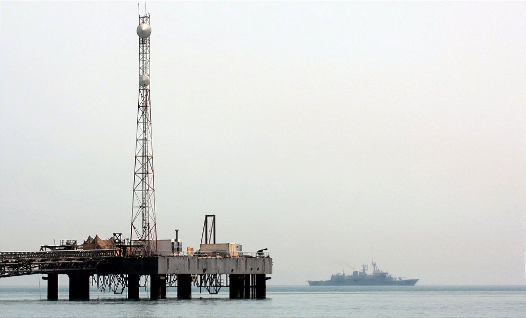 Warship patrolling the Persian Gulf near an oil platform